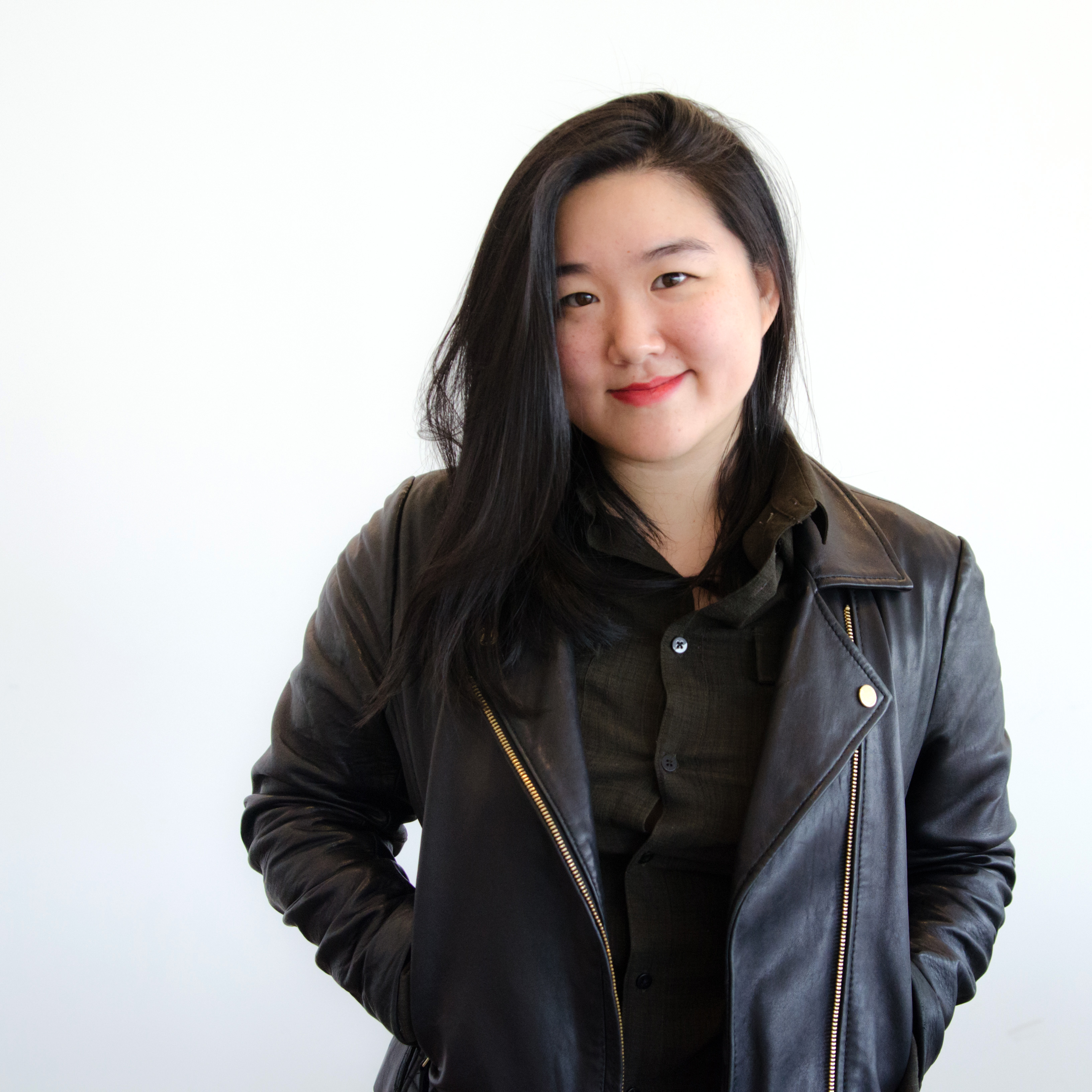 Emily in a leather jacket, smiling